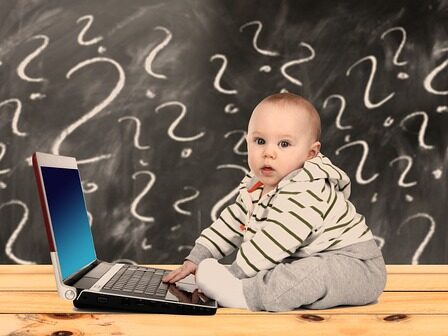 赤ちゃんがパソコンの前に座っている画像