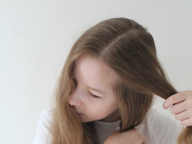女性が髪の毛を分けている画像